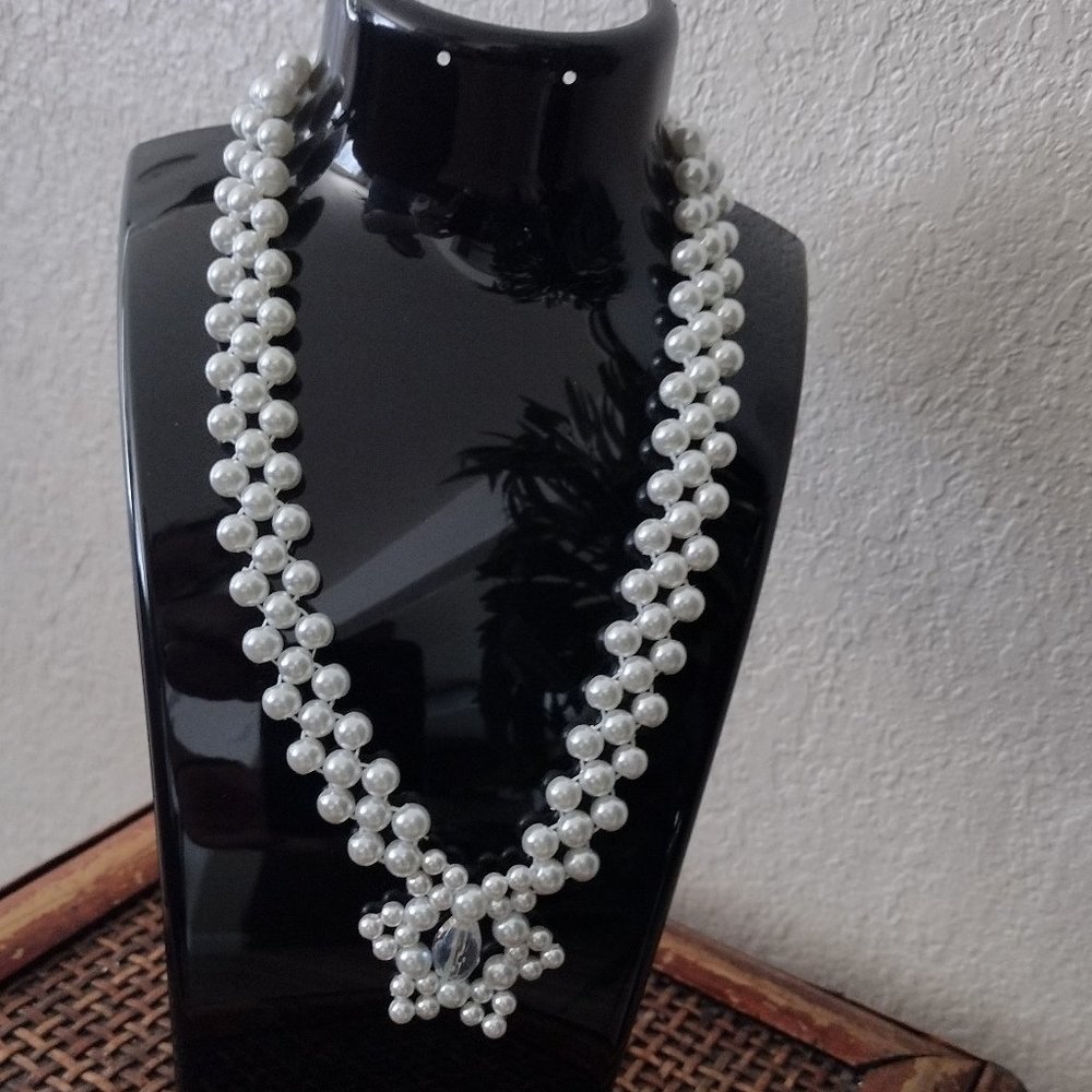 Handmade necklace with white crystal beads and star-shaped pendant.